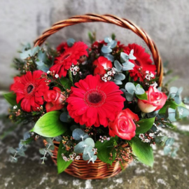 Basket with red gerberas and roses