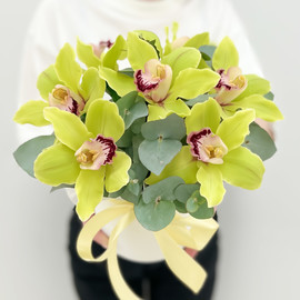 Orchids with eucalyptus in a hat box With love
