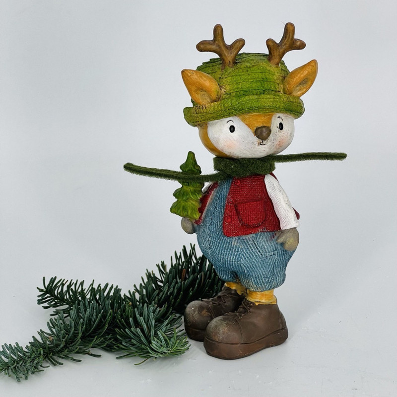 New Year's souvenir deer in a hat with a Christmas tree, standart