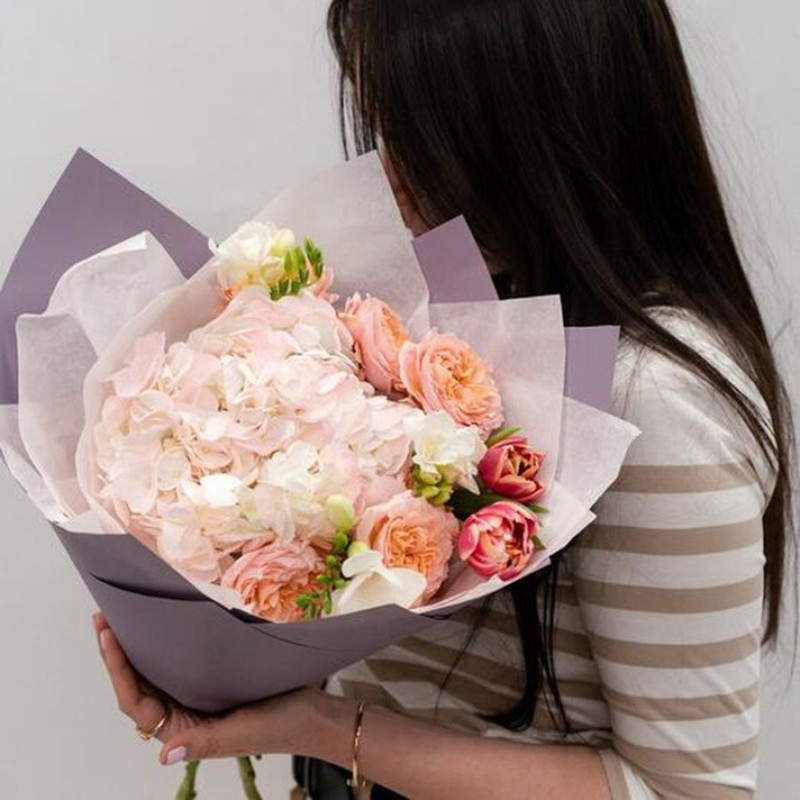 Delicate pink bouquet of flowers from hydrangea, fragrant freesia, tulips and peony spray roses, standart