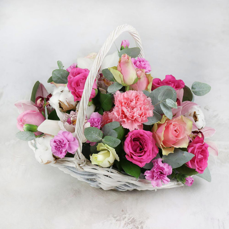 Composition of carnation orchids and roses in a basket, standart