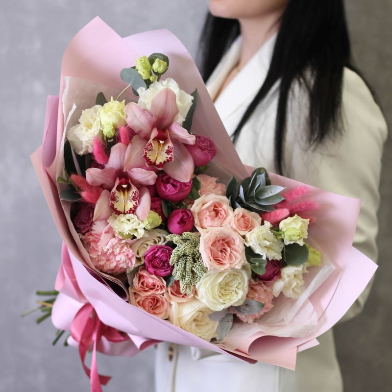 The mixed bouquet is spreading. Orchid, peony spray roses, white roses, Midland pink carnation, standart