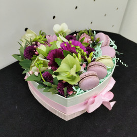 Box with flowers and cakes