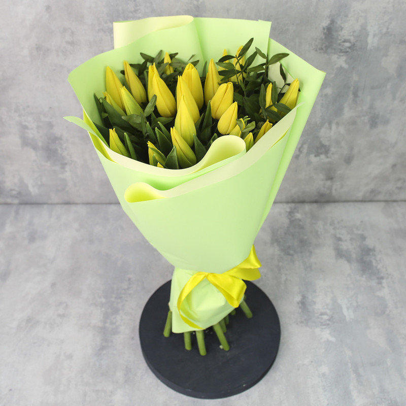 Bouquet of 25 tulips "Yellow tulips in a package with greenery", standart