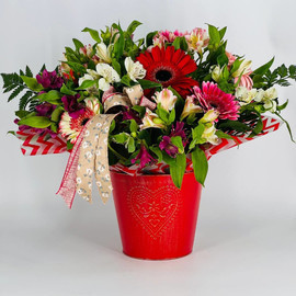Bouquet of gerberas and alstroemerias in a bucket