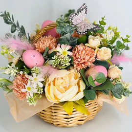 Easter gift bouquet of artificial flowers in a wicker basket