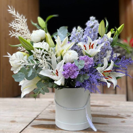 Composition of fragrant lilies and peonies, delicate delphiniums and lacy dianthus