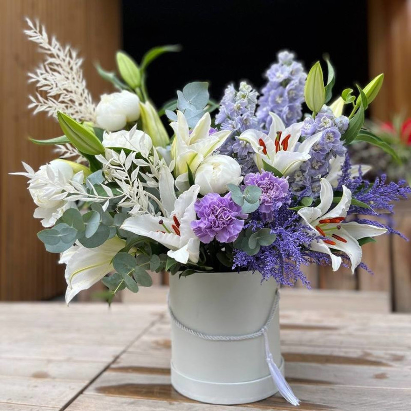 Composition of fragrant lilies and peonies, delicate delphiniums and lacy dianthus, standart