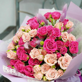 Bouquet of pink and raspberry spray roses with lagurus