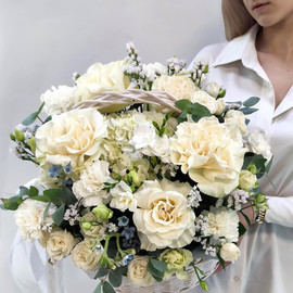 The delicacy of white French roses in a birthday basket
