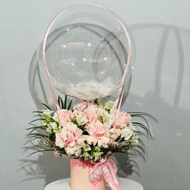 Bouquet of French roses and alstroemerias with a transparent ball