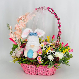 Easter basket with artificial flowers and willow with interior gnome