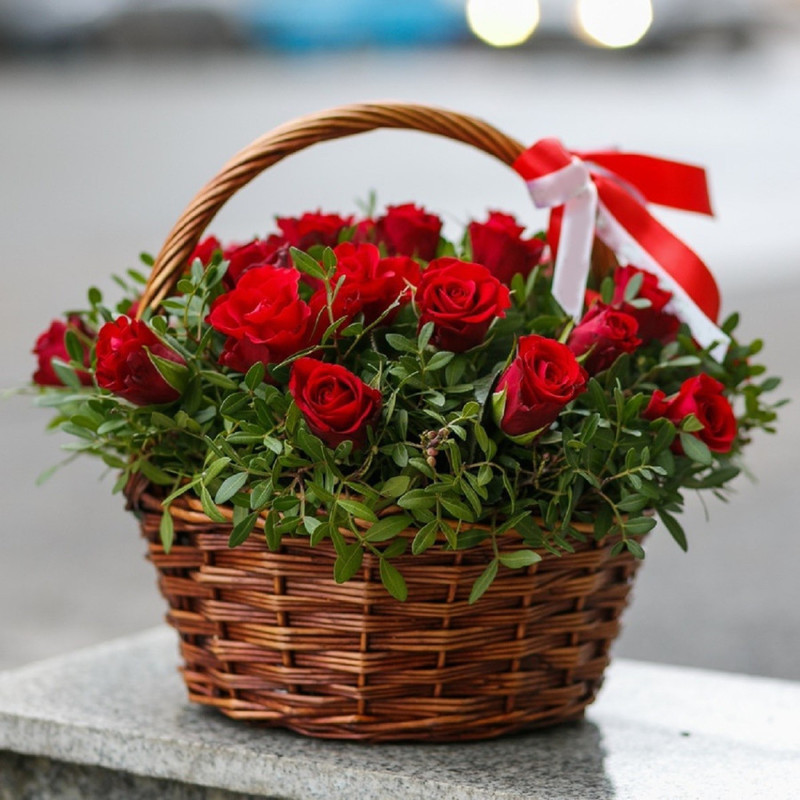Basket of red roses in greenery, standart