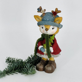 New Year's souvenir deer in a blue hat with a Christmas tree