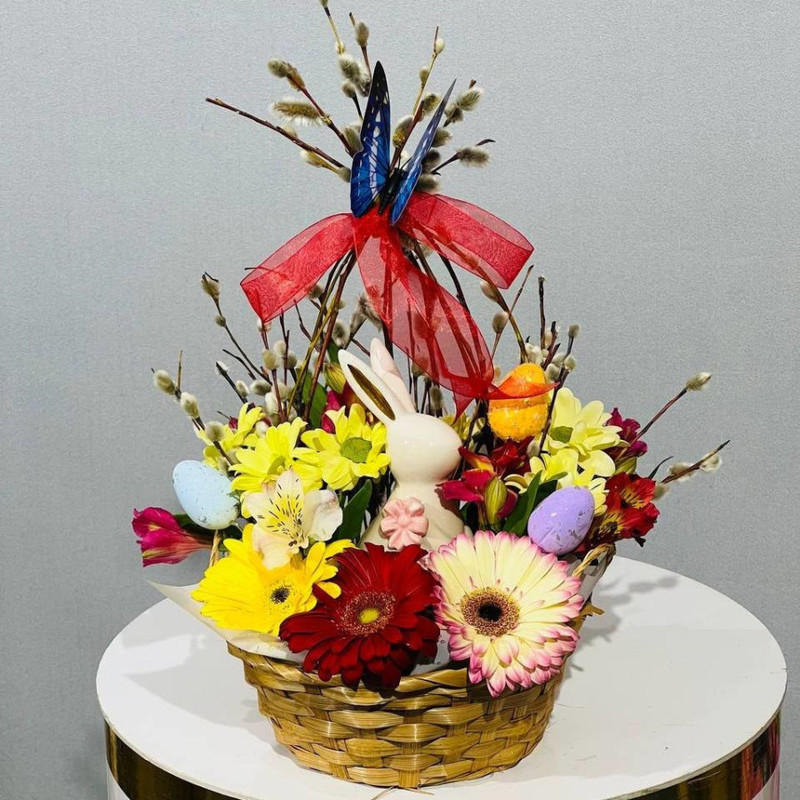 Easter gift basket with fresh flowers and willow branches, standart