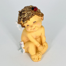 Souvenir figurine of an angel with a ladybug in her hair