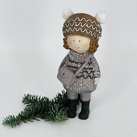 Souvenir baby in a winter sweater with a hat