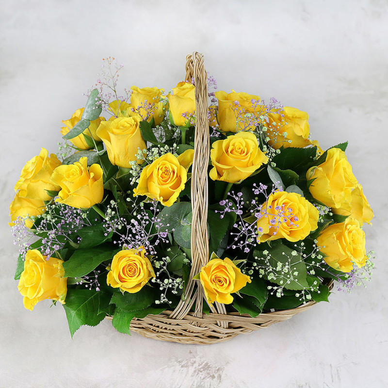 Composition of yellow roses gypsophila eucalyptus leaves in a basket, standart