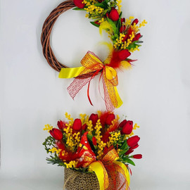 Easter wreath on the door and a bouquet of artificial flowers in a knitted flowerpot