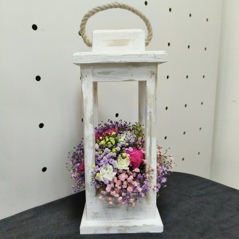 Composition in a wooden lantern with flowers, standart