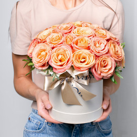 Bouquet of delicate peach roses in a Madeleine box