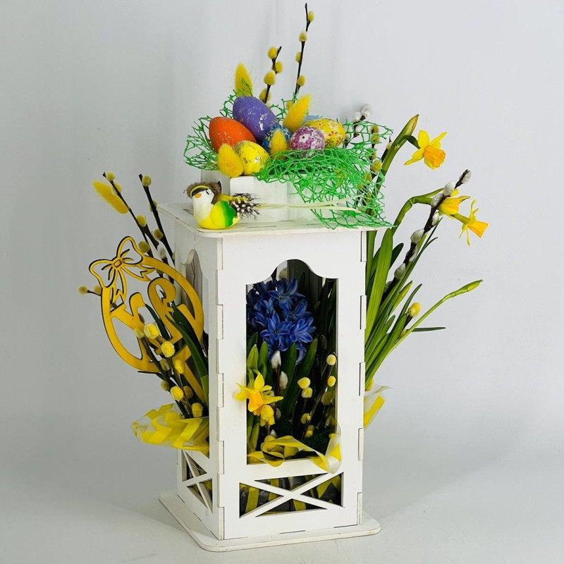 Easter gift composition of spring primroses with willow branches, standart