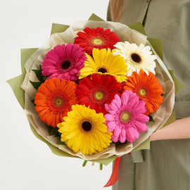 Bouquet of 9 gerberas mixed with greenery in designer decoration 40 cm