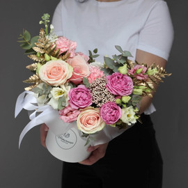 Bouquet of flowers in a box. Peony bush roses, eustoma and pink rose Diva
