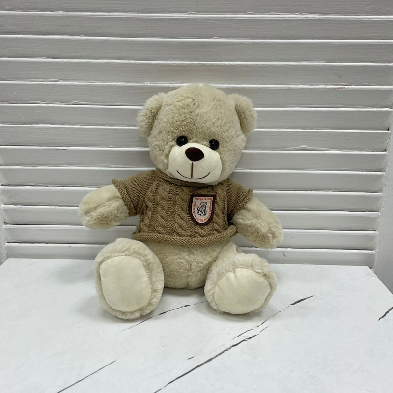 Teddy bear toy in a cream sweater, standart