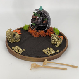 Japanese Zen rock garden with sand and incense holder creeping smoke