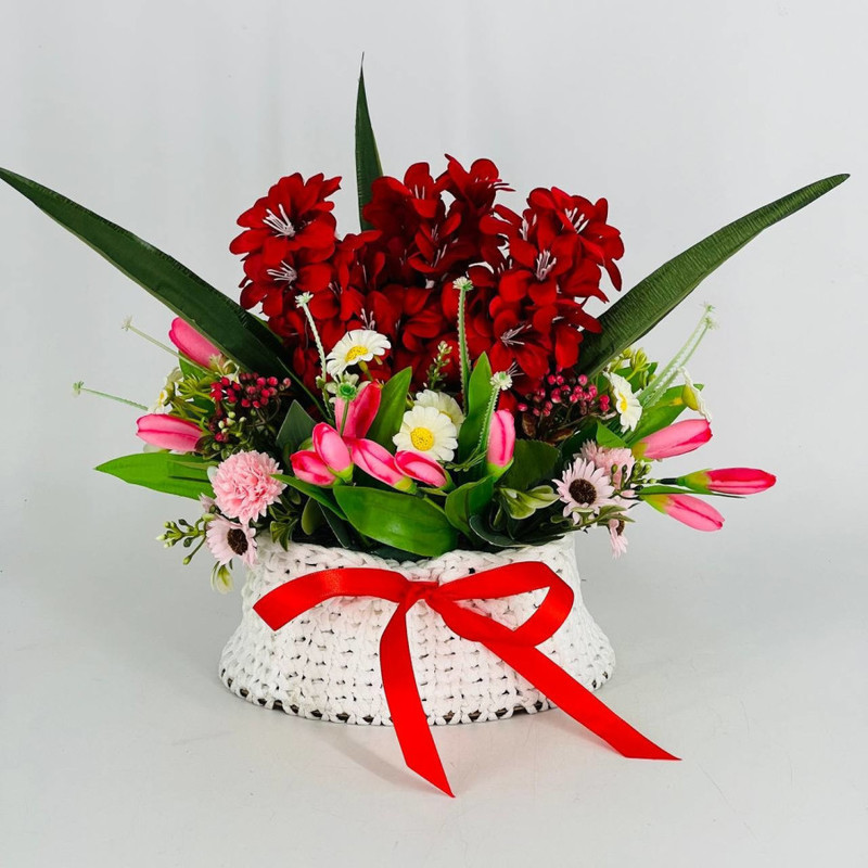 Arrangement of artificial flowers in a knitted flowerpot gift for Easter, standart