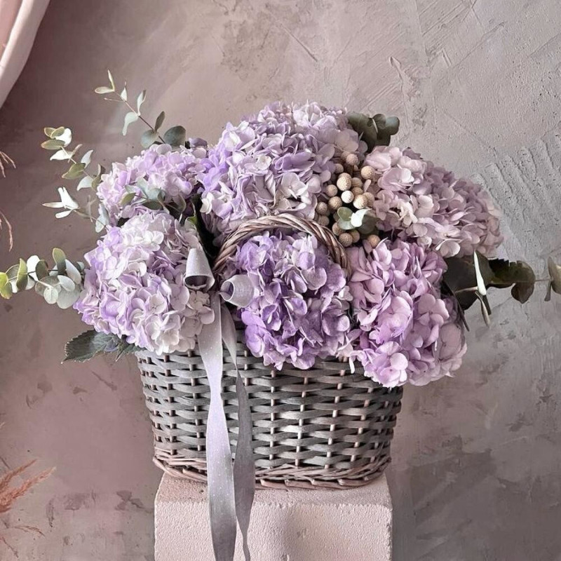 Basket with flowers: lilac hydrangea, brunia and eucalyptus sprigs, standart