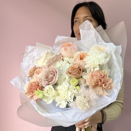 Bouquet of a mix of elite peony roses on a hydrangea pillow