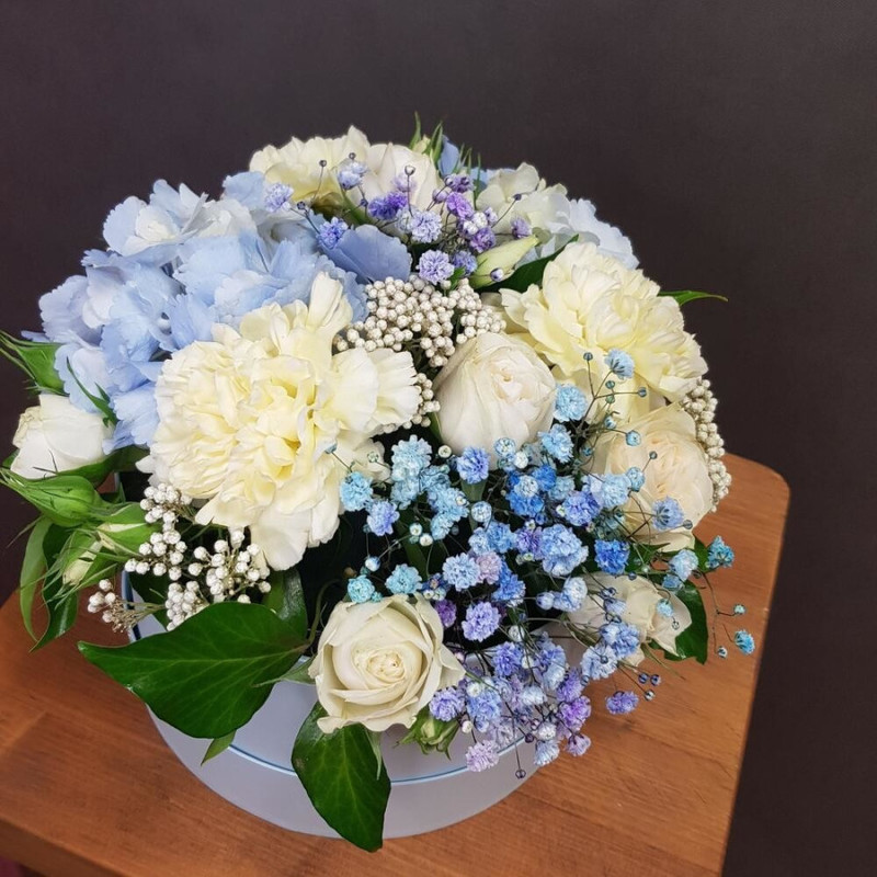 Flowers in a blue box. With blue hydrangea, dianthus and spray rose, standart