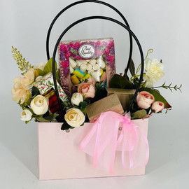 Gift bouquet in a bag made of tea and coffee with marshmallows and macaroons