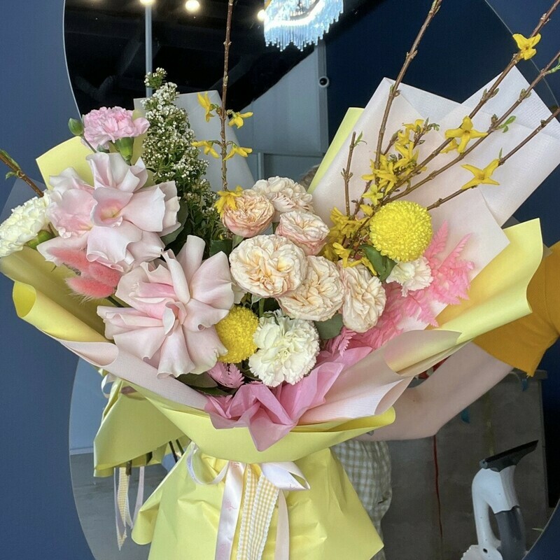 A magnificent bouquet with a French rose, a peony-shaped bush rose and flowering branches, standart