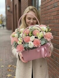 A composition in a delicate handbag with eustoma, dianthus and eucalyptus