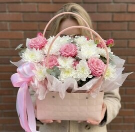 A delicate composition in a handbag with chrysanthemum, bush rose and eucalyptus