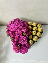 A box of bush roses and Ferrero rush candies 