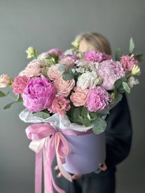 A composition with peonies in a box