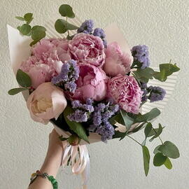 Bouquet of seasonal peonies with a statice